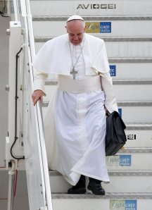 Pope Francis steps off a plane in Rome, returning from his trip to Brazil