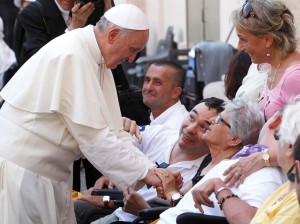 Pope greets people in wheelchairs after celebrating Mass in St. Peter's Square at Vatican