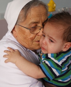 NUN COMFORTS CHILD AT CRECHE FACILITY FOR ABANDONED CHILDREN IN BETHLEHEM