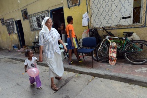 COMBONI NUN WHO WORKS WITH REFUGEES WALKS WITH CHILD IN FRONT OF SHELTER IN TEL AVIV