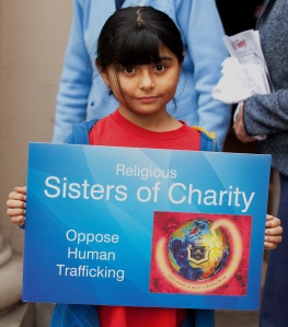 YOUNG GIRL HOLDS SIGN DURING ANTI-TRAFFICKING EVENT IN LOS ANGELES