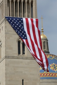 Large U.S. flag blows in wind outside national shrine in Washington on eve of 9/11 anniversary. (CNS photo/Bob Roller)