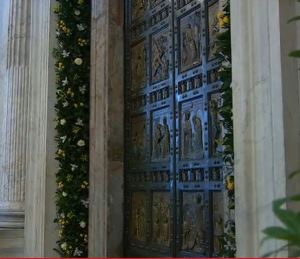 The Holy Door at St. Peter's Basilica decorated this evening. (Screen grab)