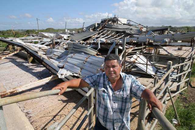 Catholic dairy farmer Gustavo Toledo stands near his destroyed farm buildings Oct. 22 in Hatillo, Puerto Rico, more than one month after Hurricane Maria devastated the island. (CNS/Bob Roller)