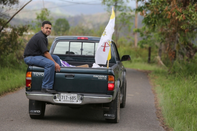 Father Carlos Francis Mendez, pastor of Immaculate Heart of Mary Church in Las Marias, Puerto Rico, delivers aid with parishioners' help to a remote area outside the town Oct. 24. It was the first aid residents of the poor area had received at their homes more than one month after Hurricane Maria devastated the island. (CNS/Bob Roller)